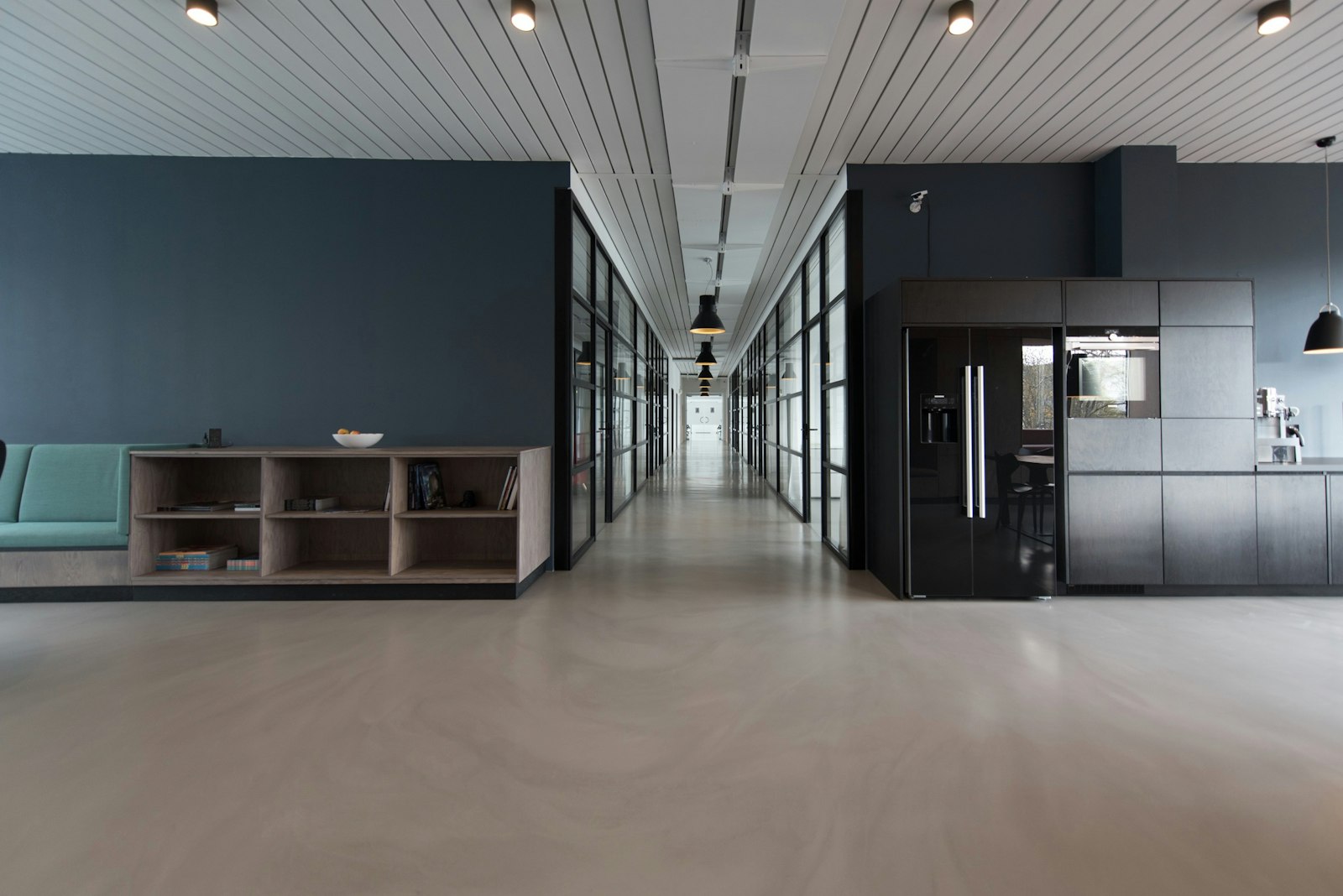 A quiet studio workroom with a long table and large windows